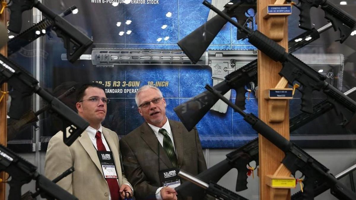 Attendees look at a display of assault rifles during the 2013 NRA Annual Meeting and Exhibits at the George R. Brown Convention Center on May 3, 2013 in Houston, Texas.