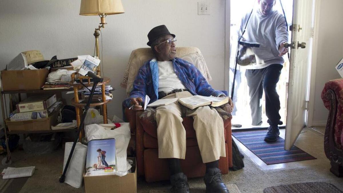 Meals on Wheels volunteer Michael Verdi of Apex delivers a meal to Gene Hooker, age 87, at his home in Raleigh in November 2015.