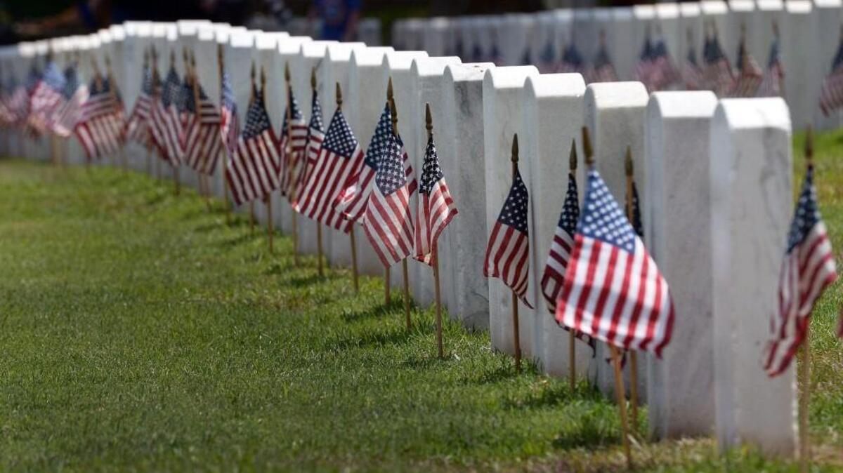 American flags on the graves of fallen soldiers during a Memorial Day weekend at Raleigh National Cemetery.