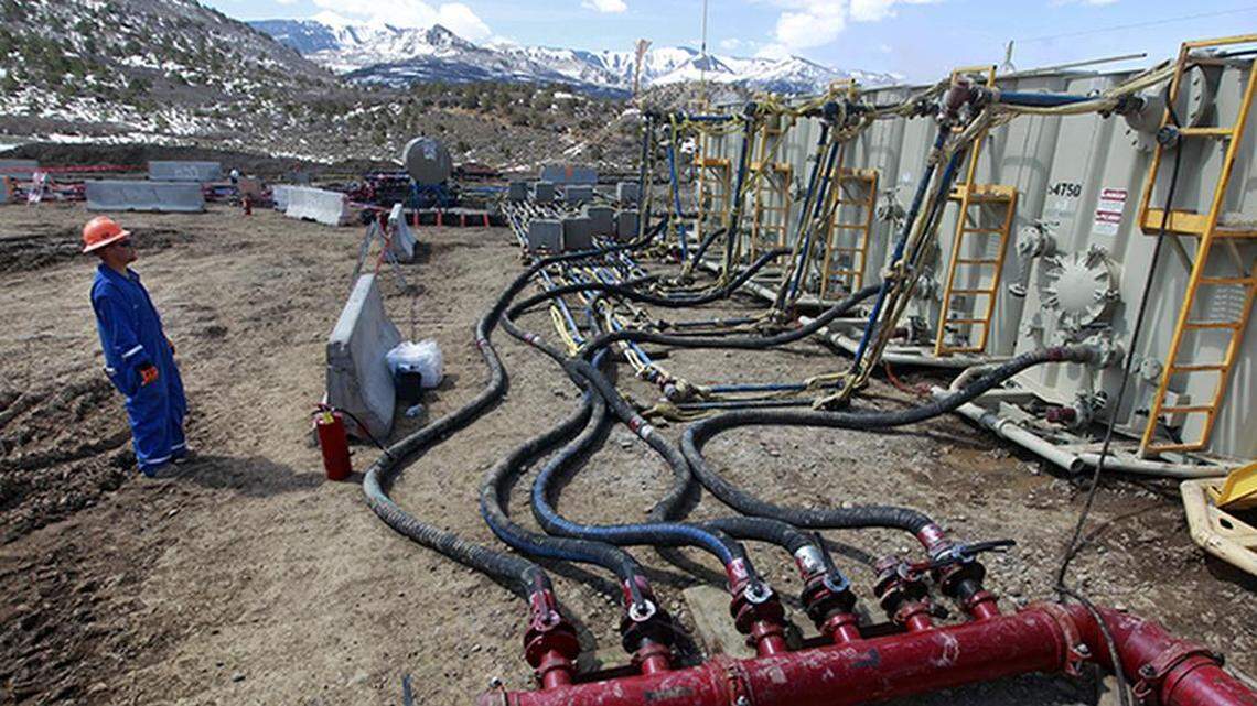A worker helps monitor water pumping pressure and temperature at an Encana Oil & Gas (USA) hydraulic fracturing and extraction site outside Rifle in western Colorado on March 29, 2013.
