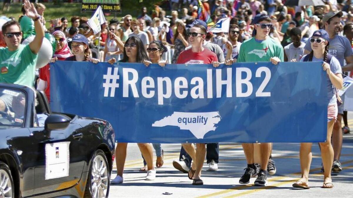 Opposition to the Republican-led NC Legislature's HB2 bill was evident as number signs were carried among the marchers at the 32nd annual NC Pride 2016 parade in Durham which kicked off down West Main Street at 1pm Saturday, September 24, 2016 with thousands marching around the streets surrounding the Duke East Campus.