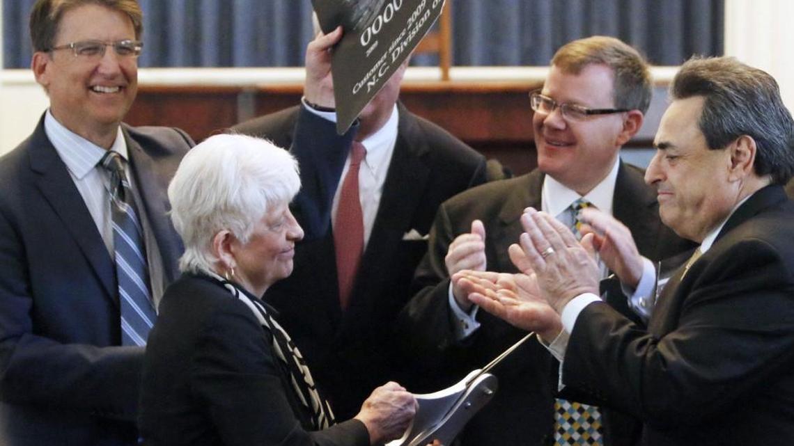 From left, NC Governor Pat McCrory, State Rep. Julia Howard, NC Commerce Secretary John Skvarla III, NC House Speaker Tim Moore, Sen. Bob Rucho participated in a ceremonial cutting up of a federal government credit card at a press announcement Tuesday, May 5, 2015 in the old NC House chamber in the State Capitol. The state announced the complete repayment of its debt to the federal government for unemployment insurance.