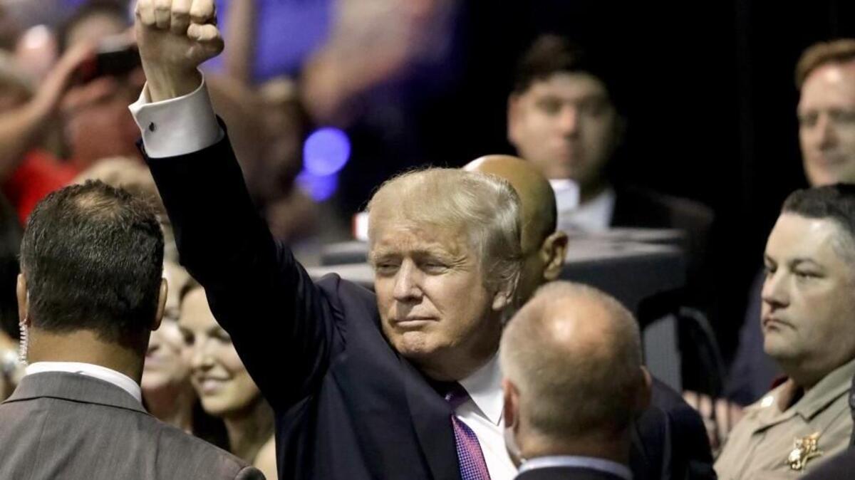 Republican presidential candidate Donald Trump raises his arm as he leaves after a rally Friday in The Woodlands, Texas. (AP Photo/David J. Phillip)