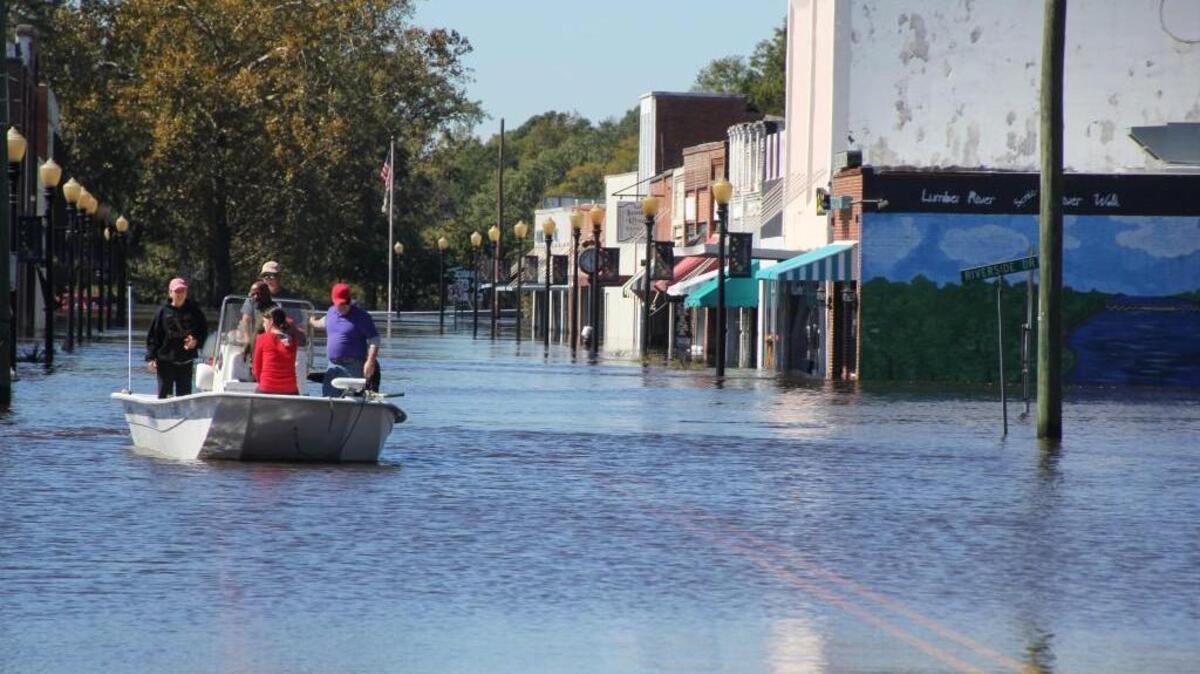 Allen Thompson navigates a boat down Main Street in Fair Bluff after Hurricane Matthew dumped heavy rains on North Carolina.