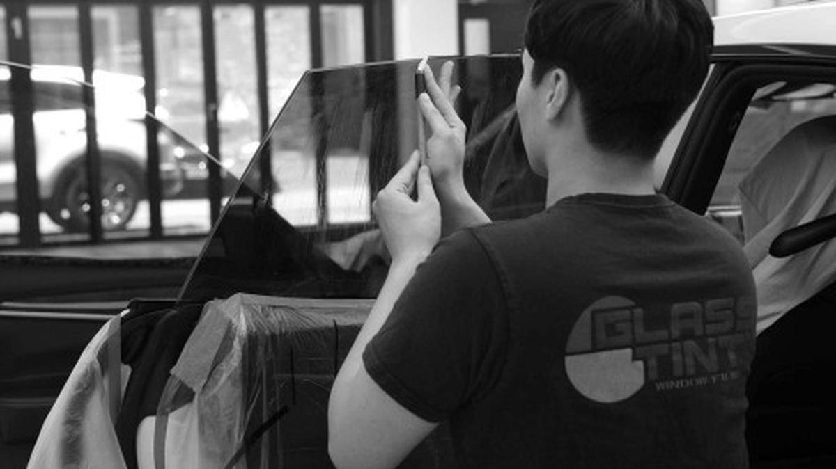 Glasstint window film installation on car side door window.
