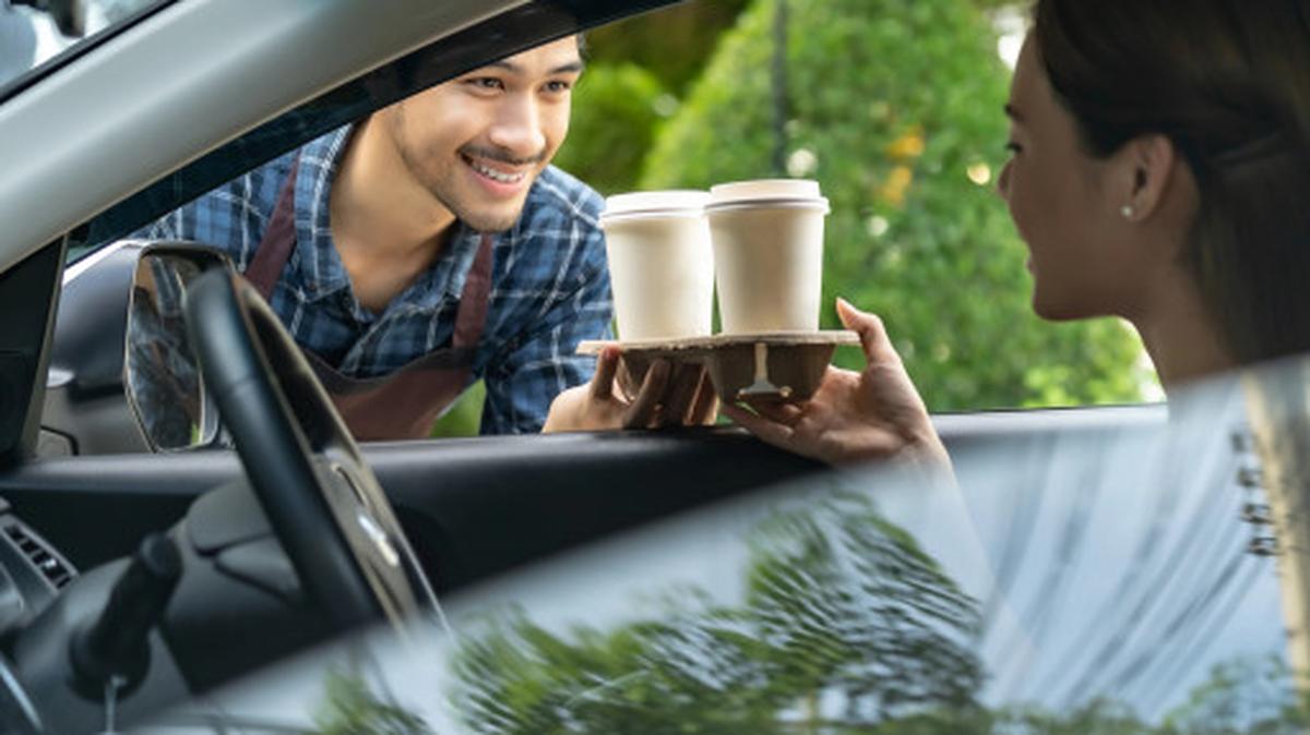 A driver picks up a coffee order.