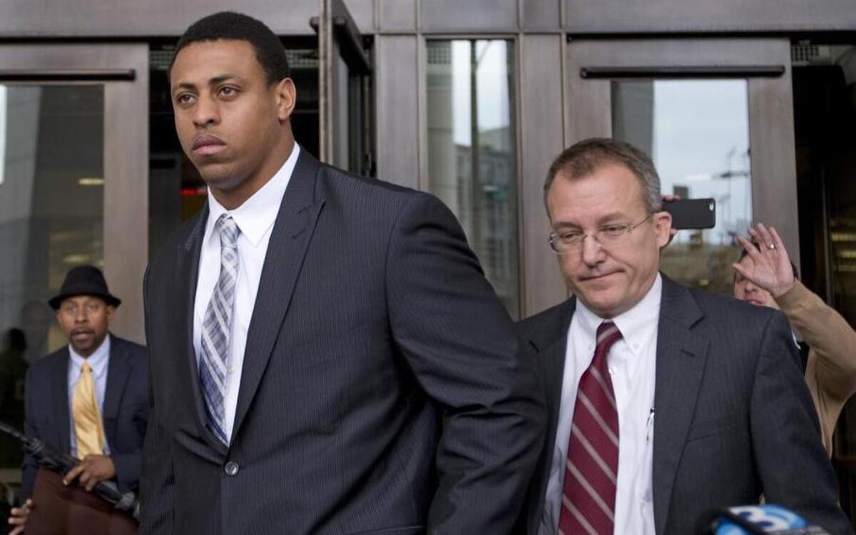 
Former Carolina Panthers player Greg Hardy, center, leaves the Mecklenburg County Courthouse after his domestic violence charges were dismissed in Charlotte on Feb. 9, 2015.
