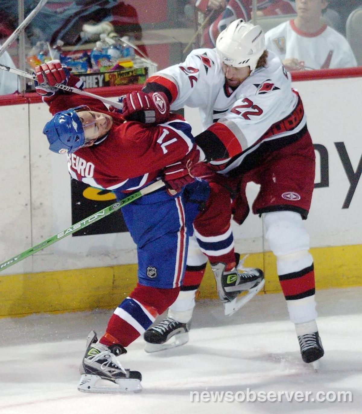 The Canes Mike Commodore (22) lays a big check on Montreal’s Mike Ribeiro (71) during the second period of Game 4 of an NHL playoff game played between the Carolina Hurricanes and the Montreal Canadiens April 28, 2006 at the Bell Center in Montreal. Rod Brind’Amour scored the winning goal for the Caners in the third period; they won 3-2 to tie the series at 2-2.