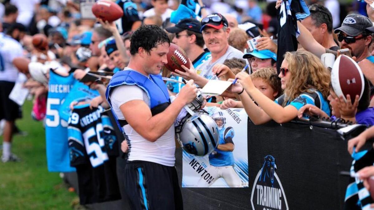 
Carolina Panthers linebacker Luke Kuechly (59) signs autographs for fans after practice on Sunday at Wofford College in Spartanburg. Kuechly is awaiting a big contract extension, which could happen before the season. 
