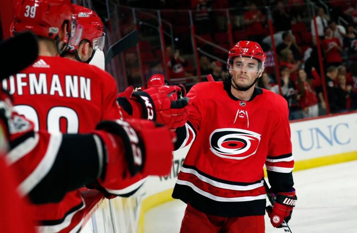 The Canes' Derek Ryan (7) celebrates as he comes back to the bench after he scored during the second period.