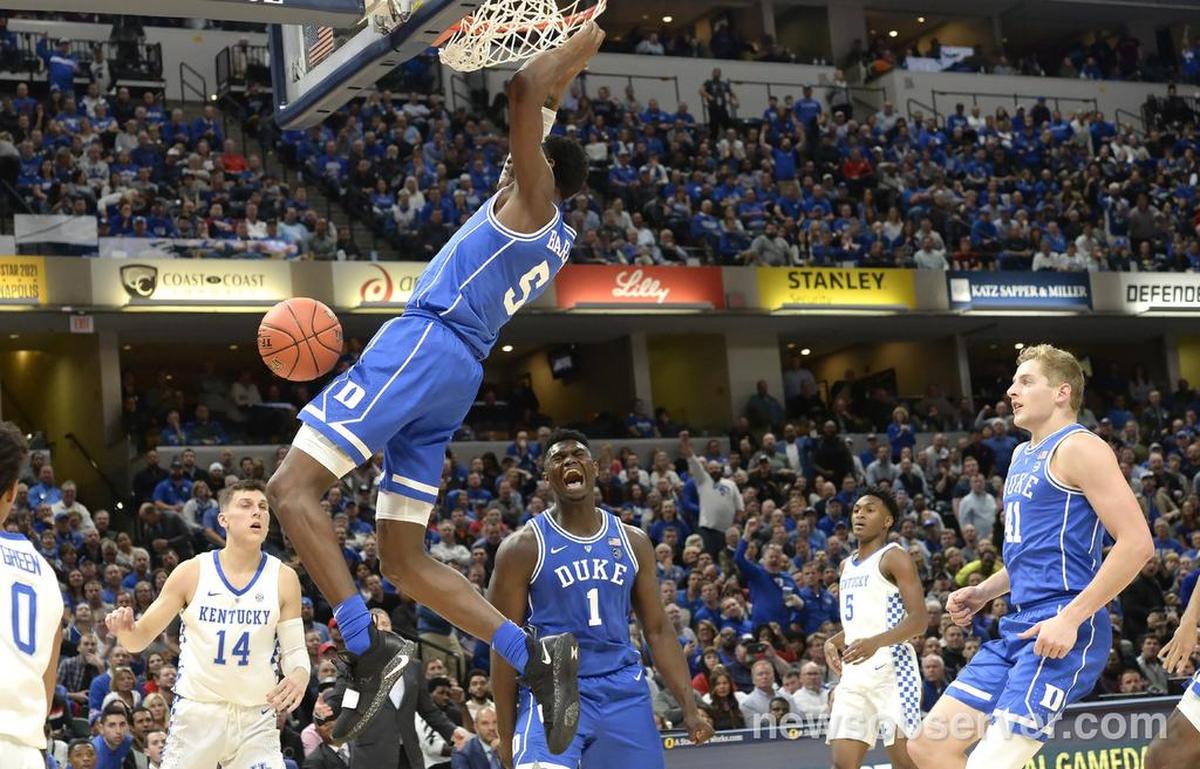 Duke forward R.J. Barrett (5) dunks the ball as teammates forward Zion Williamson (1) and forward Jack White (41) react in the second half. Duke defeated Kentucky 118-84 in the Champions Classic at the Bankers Life Fieldhouse in Indianapolis, Indiana, Tuesday, Nov. 6, 2018.