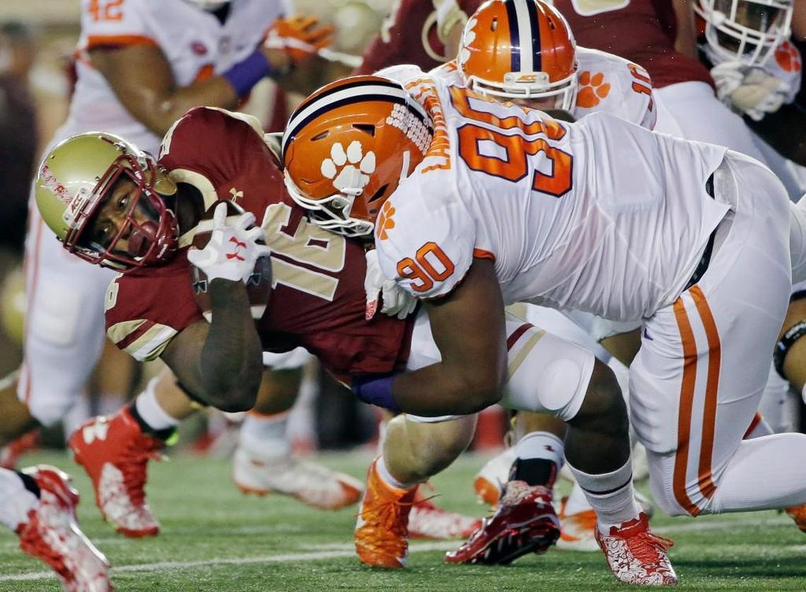 In this Oct. 7, 2016, file photo, Boston College running back Davon Jones (16) is brought down by Clemson defensive tackle Dexter Lawrence (90). Lawrence is a graduate of Wake Forest High School.