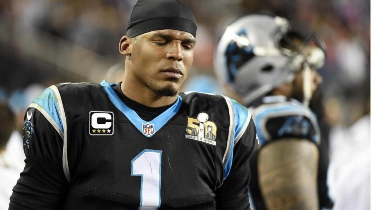 Carolina Panthers quarterback Cam Newton looks pained as he walks the sideline late in the fourth quarter of Sunday’s 24-10 loss to Denver in Super Bowl 50.