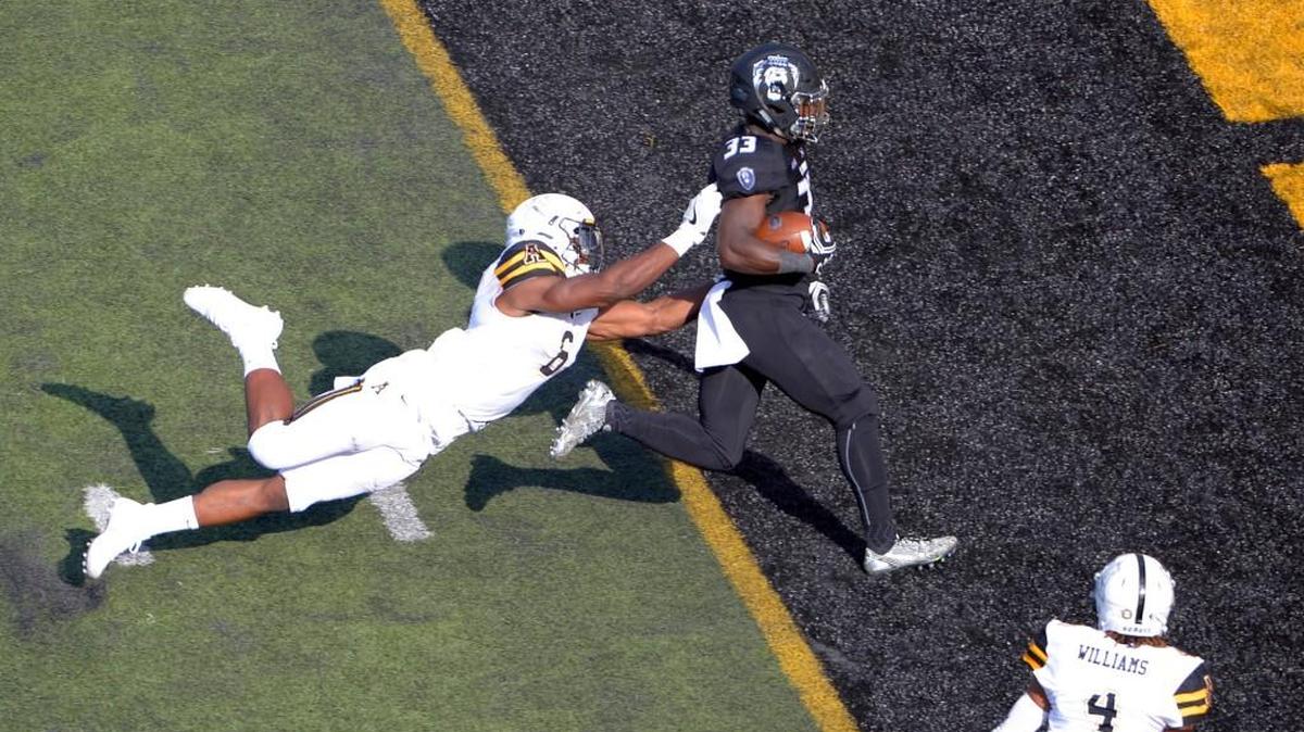 Old Dominion running back Ray Lawry (33) drags Appalachian State outside linebacker Kennan Gilchrist (6) into the end zone for the touchdown during Saturday’s game in Boone. during an NCAA college football game in Boone, N.C., Saturday, Sept. 10, 2016. (Bruce Chapman/Winston-Salem Journal via AP)