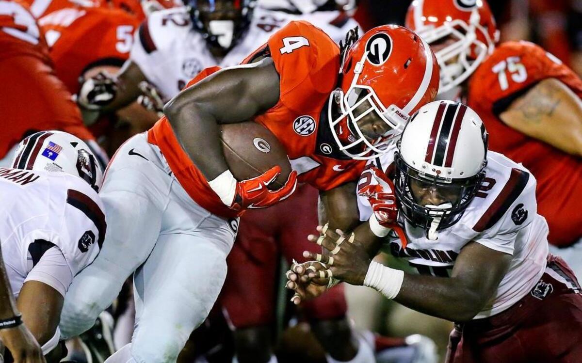 
Georgia tailback Keith Marshall goes head to head with Gamecocks Skai Moore powering his way in for a 3-yard touchdown run during the fourth quarter on Saturday, Sept. 19, 2015, at Sanford Stadium in Athens, Ga. Georgia won, 52-20. 
