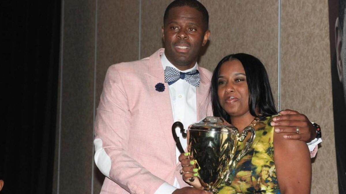 LeVelle Moton and Shanail Monick, 33, pose for a photo after she wins Single Mother of the Year.