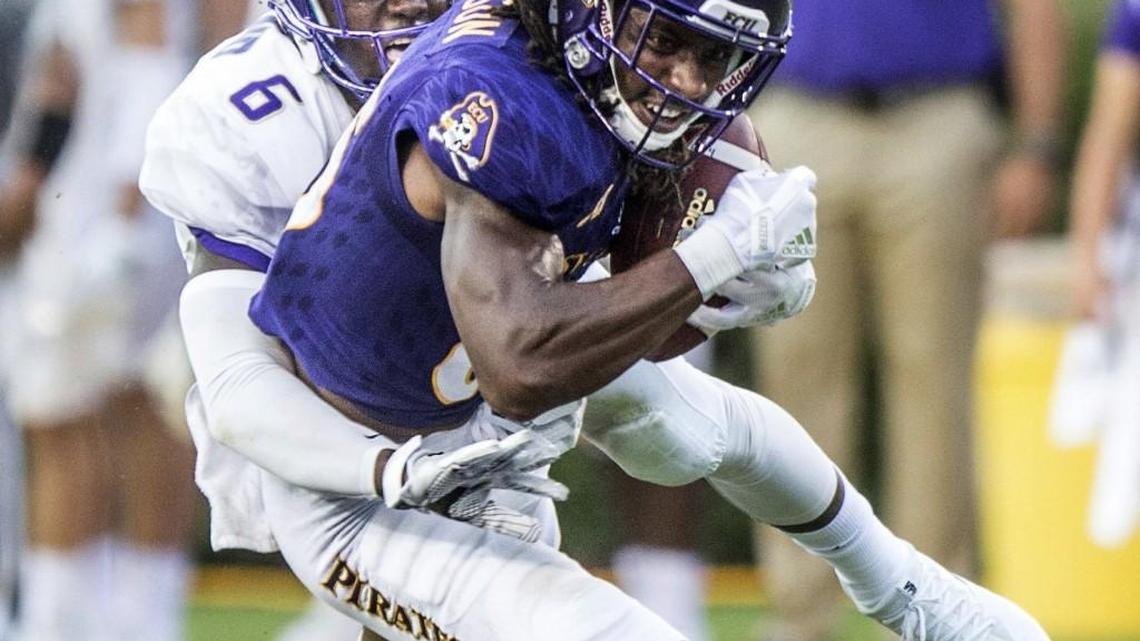 East Carolina's Davon Grayson, front, is taken down by James Madison's Kyre during an NCAA college football game Saturday, Sept. 2, 2017, in Greenville, N.C, (Molly Mathis /The Daily Reflector via AP)