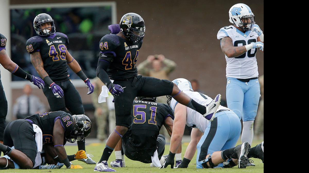 
East Carolina linebacker Zeek Bigger (44) celebrates after stopping North Carolina's Romar Morris (21) during the first half of UNC's game against East Carolina at Dowdy-Ficklen Stadium in Greenville, N.C., Saturday, September 20, 2014. 
