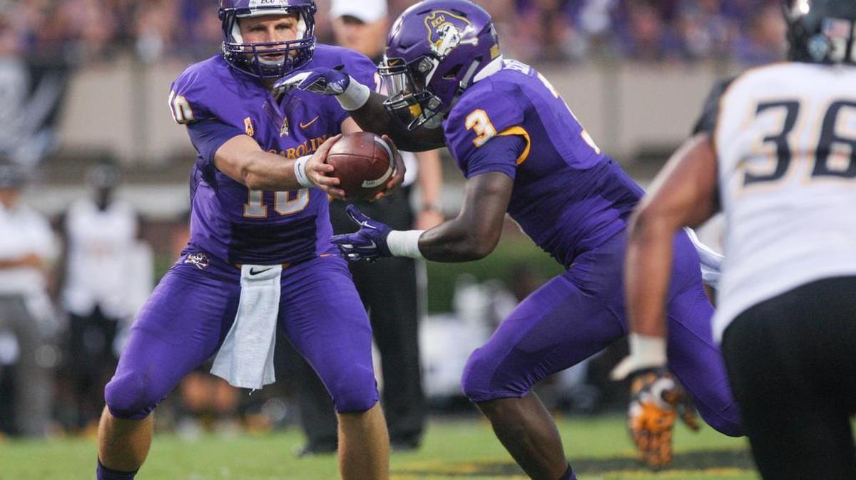 
ECU's Blake Kemp (10) passes the ball to Anthony Scott (3) during their game against Towson at Dowdy-Ficklen Stadium on Sept. 5. 
