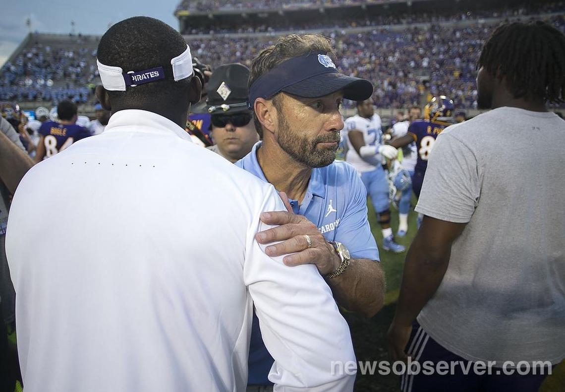 North Carolina coach Larry Fedora, seen congratulating East Carolina coach Scottie Montgomery earlier this season, is trying to recruit Sun Valley QB Sam Howell, who has committed to Florida State.