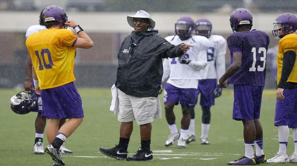 
East Carolina coach Ruffin McNeill directs quarterback Blake Kemp (10) during NCAA college football practice in Greenville on August 11, 2015.
