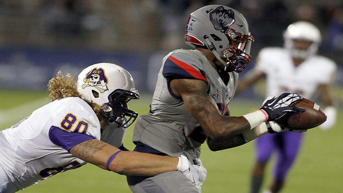 Connecticut Jamar Summers, right, intercepts an East Carolina pass during the second quarter of their game in East Hartford, Conn.