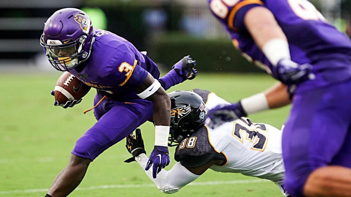 
East Carolina's Travon Simmons (3) breaks free from Towson's Chris Tedder during an NCAA college football game at Dowdy-Ficklen Stadium on Saturday, Sept. 5, 2015, in Greenville, N.C. (Aileen Devlin/The Daily Reflector via AP)
