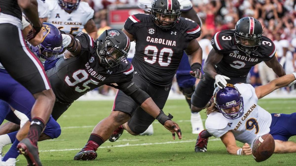 South Carolina defensive lineman Dante Sawyer (95), Taylor Stallworth (90), and Chris Lammons (3) attempt to recover a fumble by East Carolina quarterback Philip Nelson (9) during the first half.