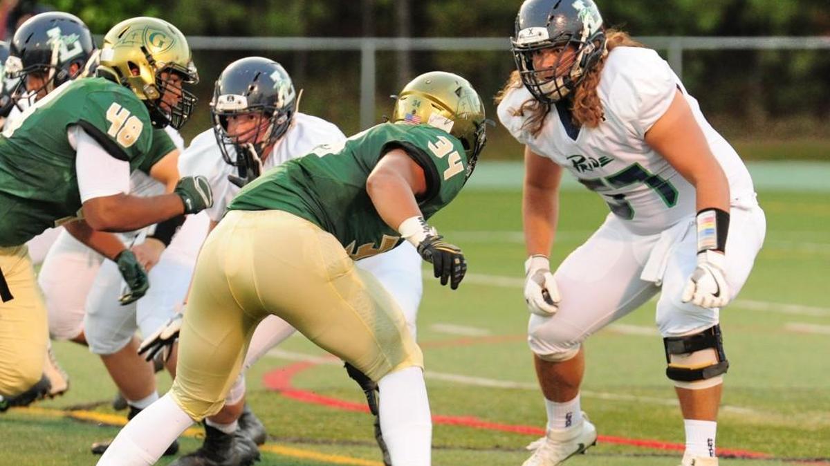 Cardinal Gibbons' Jalen Brooks (34) matches up with Leesville's Peyton Winstead (57). Leesville Road visited Cardinal Gibbons Crusaders on Sept. 22, 2017.