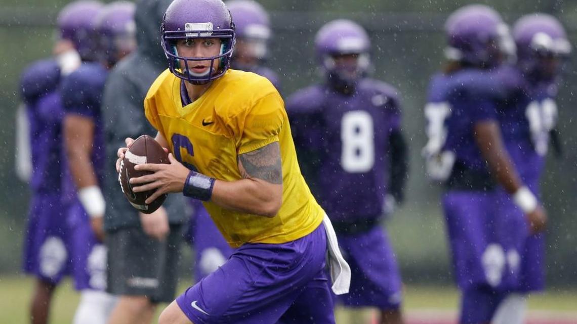 
East Carolina quarterback Kurt Benkert rolls out to pass during NCAA college football practice in Greenville. 
