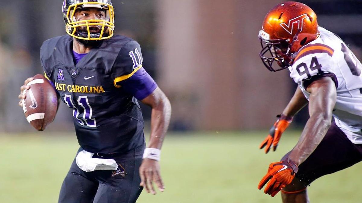 
East Carolina's James Summers (11) looks to pass the ball while being pursued by Virginia Tech's Trevon Hill (94) during the second half of an NCAA college football game in Greenville, N.C., Saturday, Sept. 26, 2015. East Carolina won 35-28. (AP Photo/Karl B DeBlaker)
