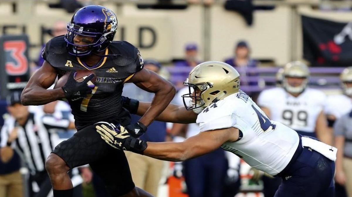 East Carolina's Zay Jones carries the ball as Navy's Micah Thomas tries to make a tackle during the first half at Dowdy-Ficklen Stadium in Greenville.
