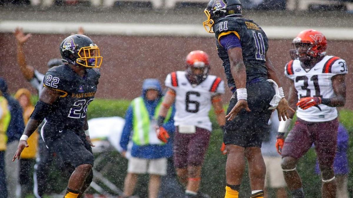 
East Carolina’s James Summers (11) celebrates with teammate Chris Hairston (22) after scoring a touchdown as Virginia Tech’s Mook Reynolds (6) and Brandon Facyson (31) look on during the first half Saturday. East Carolina won 35-28. 
