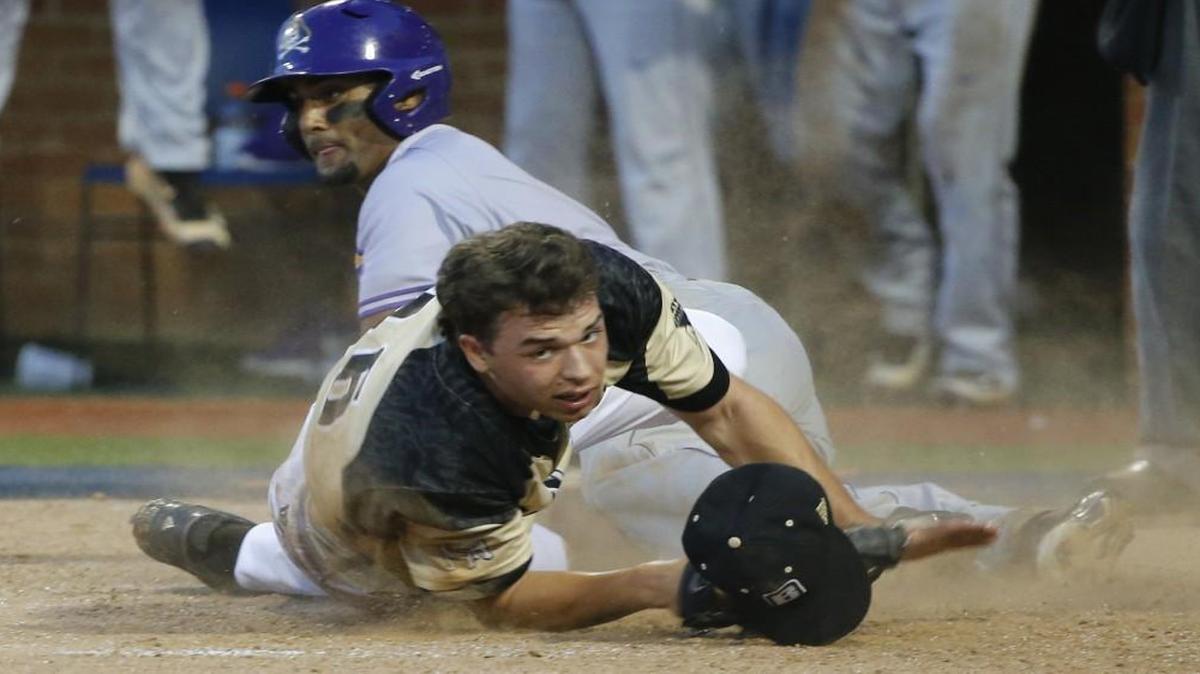 Bryant pitcher Logan Lessard, front, looks for the ball as he tried to tag East Carolina's Garrett Brooks, background, at the plate during an NCAA regional baseball game in Charlottesville, Va..