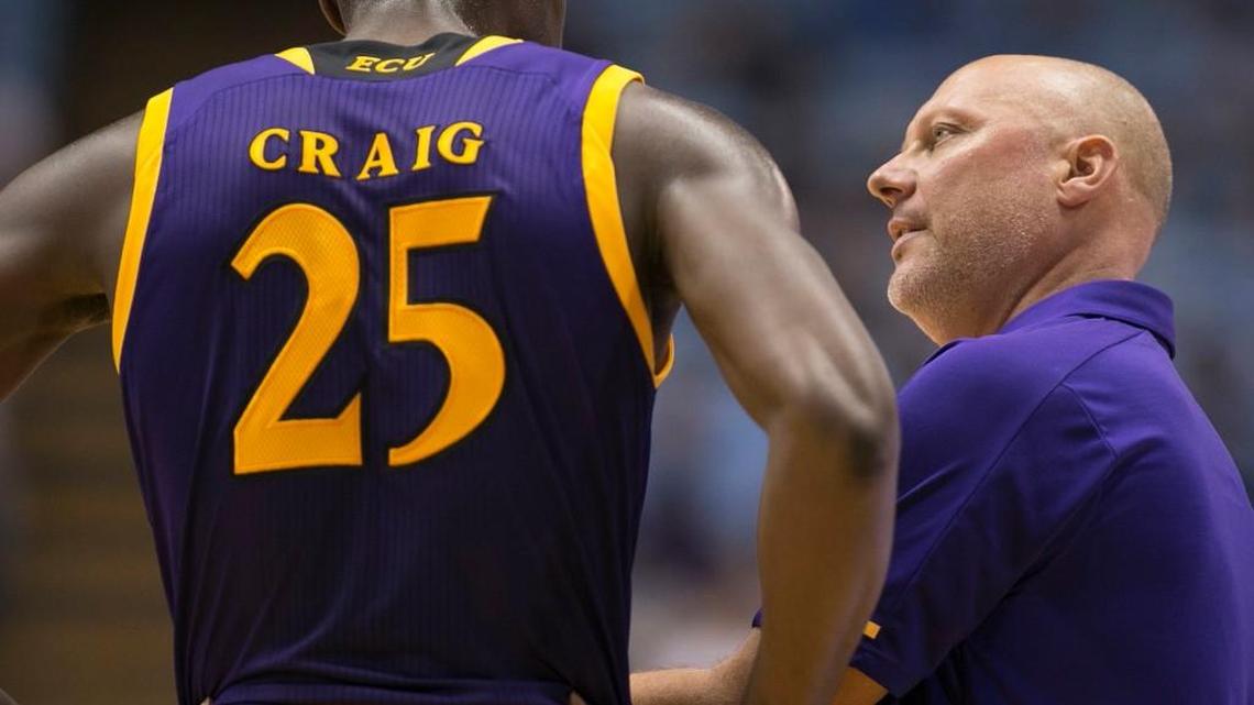 East Carolina coach Jeff Lebo, right, talks with Jabari Craig earlier this month. It was announced Wednesday that Lebo is leaving the Pirates.