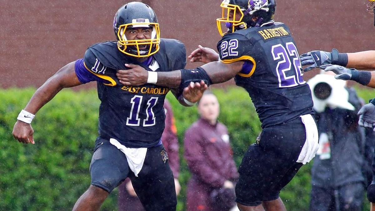 
East Carolina's James Summers (11) celebrates after scoring a touchdown with teammate Chris Hairston (22) during the second half against Virginia Tech in Greenville. 
