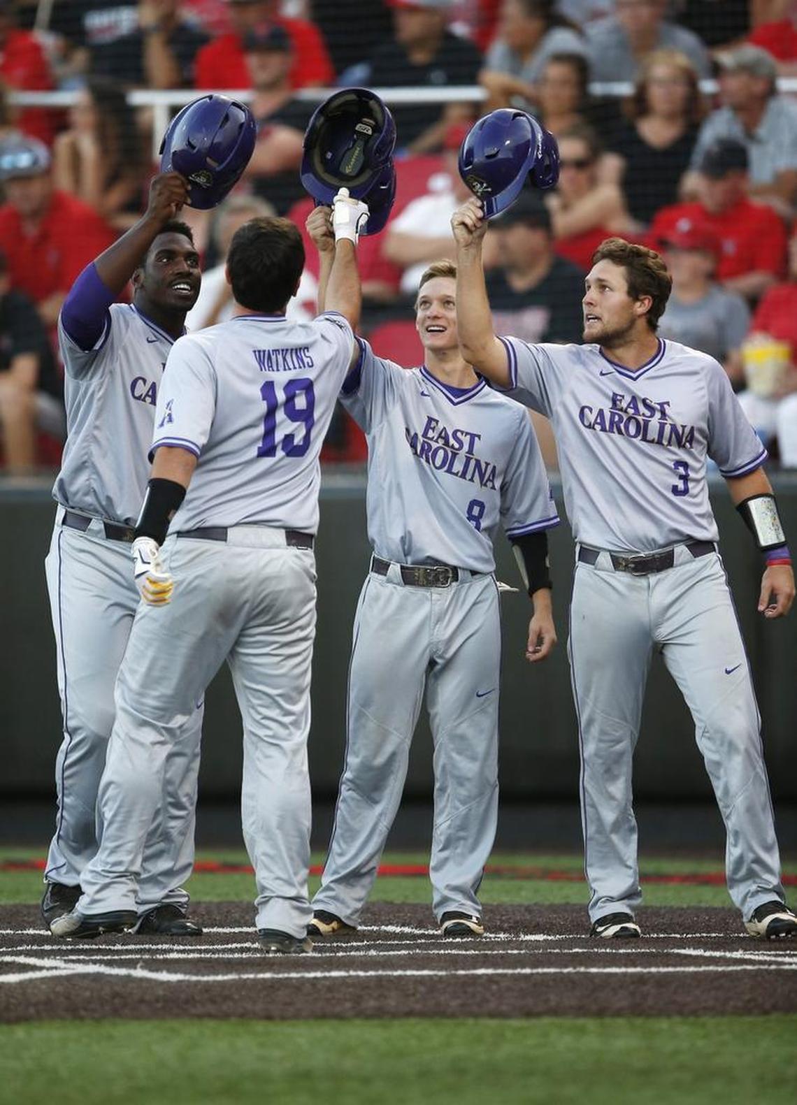 East Carolina's Dwanya Williams-Sutton, Turner Brown (8), and Charlie Yorgen (3) celebrate with Travis Watkins (19) after he hit a grand slam against Texas Tech during their NCAA college baseball tournament super regional game in Lubbock, Texas.