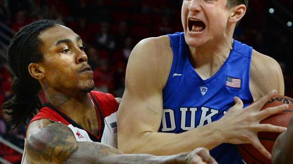 Duke guard Grayson Allen (3) is fouled by N.C. State guard Cat Barber (12) late in the second half as the Blue Devils defeated the Wolfpack 88-78 at the PNC Arena Saturday. Allen was 5-5 from the foul line and scored 28 points. Barber led the Wolfpack with 19 points.