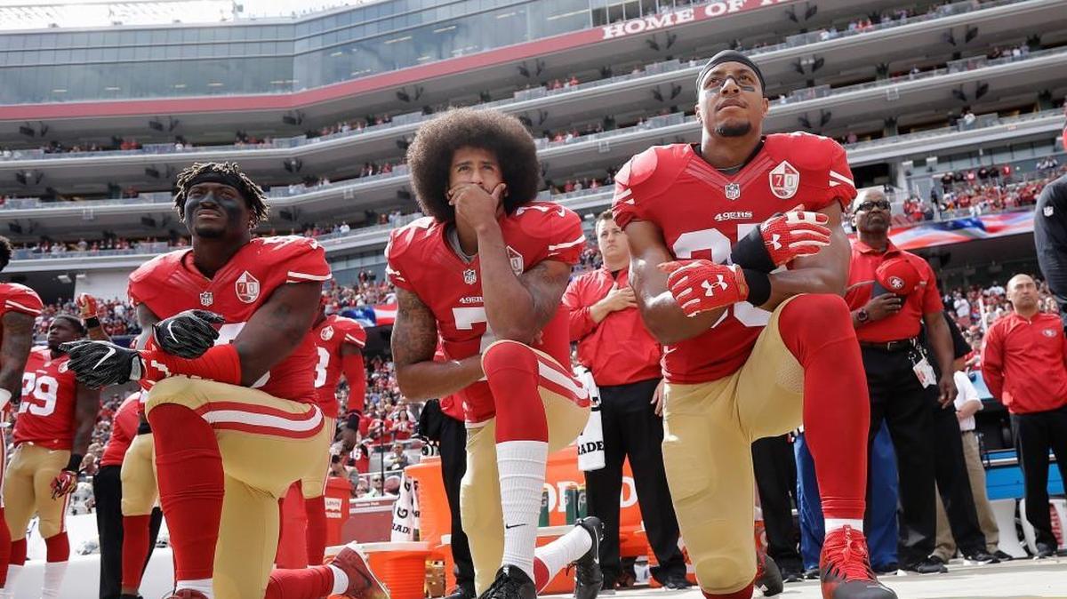 San Francisco 49ers linebacker Eli Harold, left, quarterback Colin Kaepernick, center, and safety Eric Reid kneel during the national anthem before game against the Dallas Cowboys in Santa Clara, Calif., on Oct. 2, 2016. (AP Photo/Marcio Jose Sanchez, File)