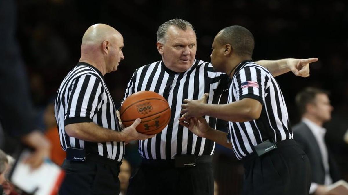 ACC officials (from left) Tim Comer, Jamie Luckie and Michael Stephens confer during the North Carolina vs. Boston College game on February 9, 2016 at the Conte Forum in Chestnut Hill, Mass.