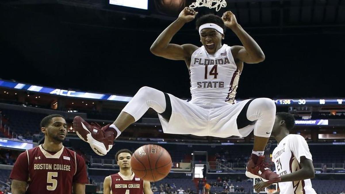 Florida State guard Terance Mann (14) reacts after dunking the ball in front of Boston College forward Garland Owens (5) and guard Jerome Robinson (1) during the first half in the Atlantic Coast Conference tournament.