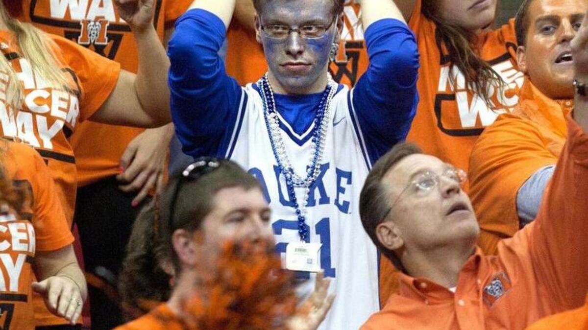A lone Duke fan, surrounded by Mercer fans, reacts to a foul being called on Duke in the second half of play. Duke University Blue Devils played the Mercer Bears in the second round of the NCAA Men's Basketball Tournament at the PNC Arena on March 21, 2014. Mercer won the game 78-71.