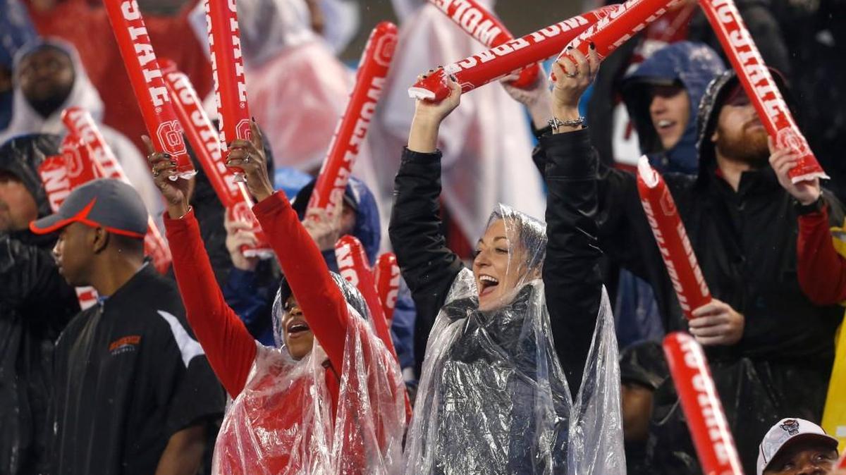 Fans cheer on the Wolfpack during the second half of Mississippi State's 51-28 victory over N.C. State in the Belk Bowl at Bank of America Stadium in Charlotte, N.C., Wednesday, December 30, 2015.