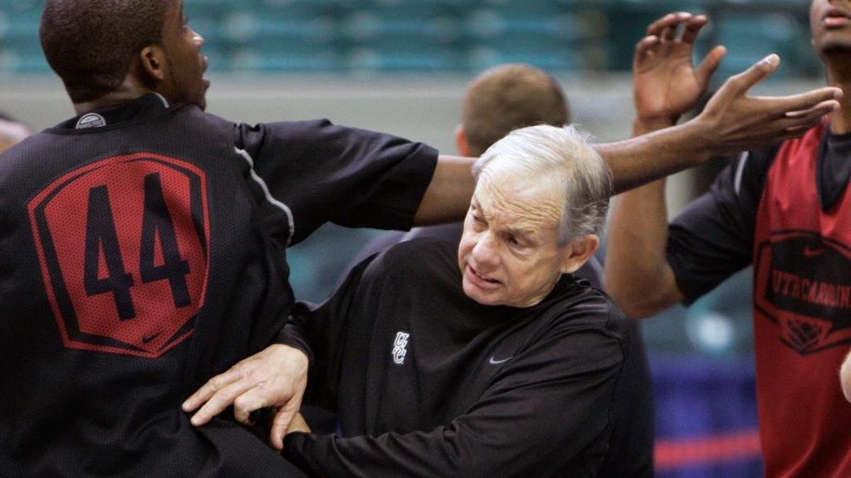 South Carolina coach Dave Odom gets tangled up with South Carolina forward Sam Muldrow (44) during a practice session for the SEC basketball tournament in the Georgia Dome in Atlanta on March 12, 2008.