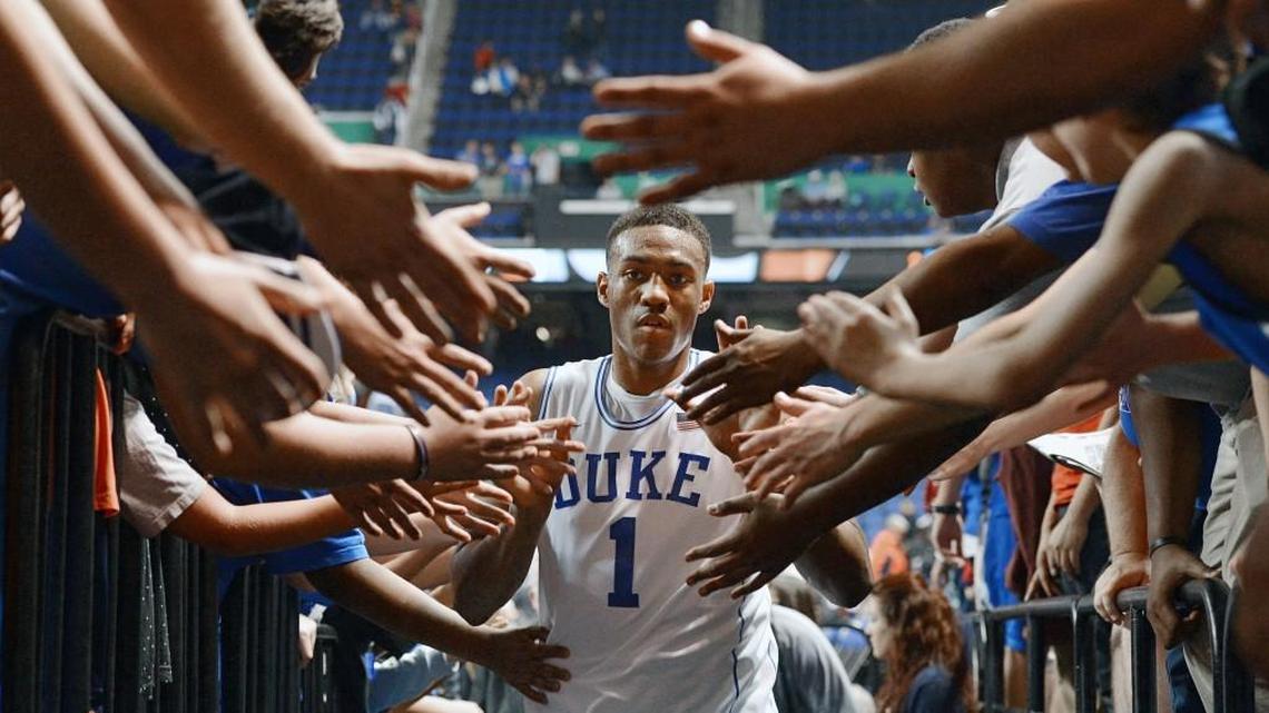 Duke forward Jabari Parker (1) walks through a phalanx of arms and hands as he heads to the locker room after the Blue Devils eliminated the Wolfpack. Duke advanced to face Virginia in the championship game of the ACC Men's Basketball Tournament defeating N.C. State 75-67 in Greensboro, N.C. Saturday, March 15, 2014.