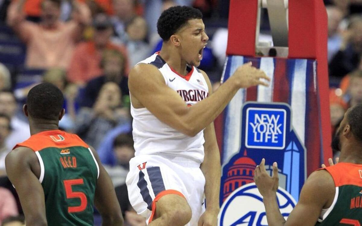 Virginia’s Isaiah Wilkins (21) celebrates after slamming in two during the second half of Virginia’s 73-68 victory over Miami in the semifinals of the ACC Tournament on Friday. The No. 2 seed Cavaliers face No. 1 seed North Carolina in the finals Saturday night.