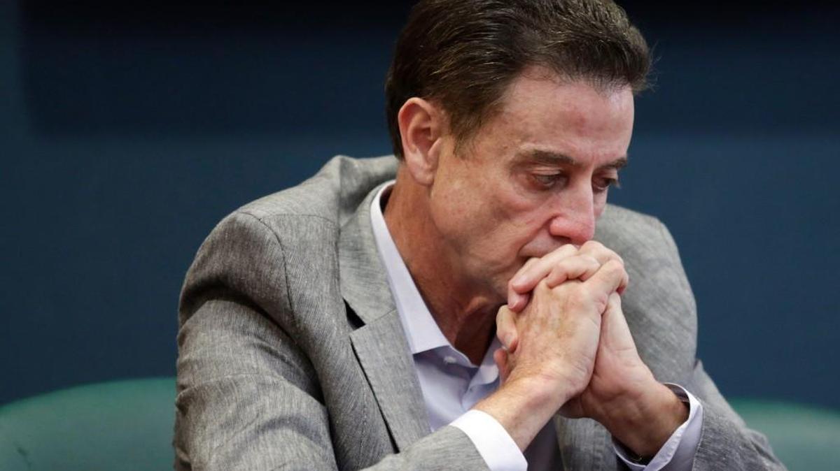 Louisville basketball coach Rick Pitino listens during an NCAA college basketball news conference on Thursday. The NCAA suspended Pitino on Thursday for five ACC games following a sex scandal investigation. A former men’s basketball staffer is alleged to have hired strippers to entertain players and recruits.