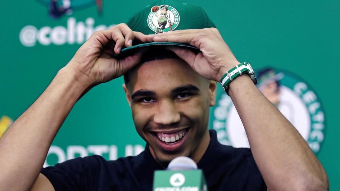 Boston Celtics NBA basketball first-round draft pick Jayson Tatum puts on a cap during a press availability at the team's practice facility in Waltham, Mass., on June 23, 2017. With Tatum, a 6-foot-8 small forward, the Celtics get a player who was a polished scoring threat during his lone season at Duke. (AP Photo/Charles Krupa)