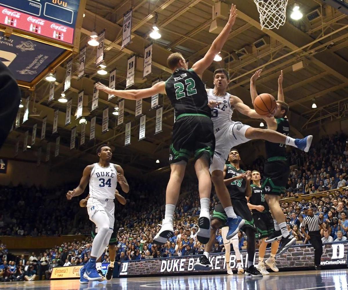 Duke guard Grayson Allen (3) splits Utah Valley forward Isaac Neilson (22) and guard Conner Toolson (11) in the first half.