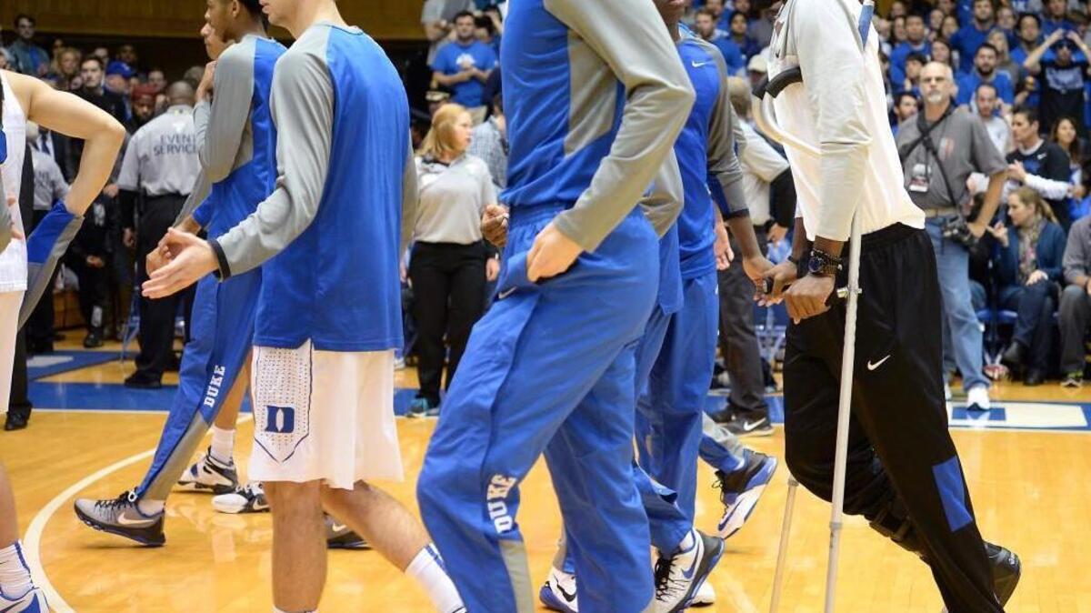Duke's Amile Jefferson stands on crutches as his teammates are introduced prior to the Elon game Dec. 28, 2015 at Cameron Indoor Stadium in Durham.